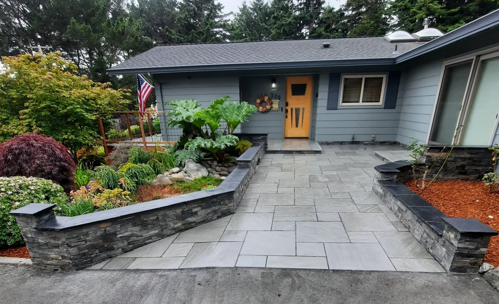 Entry courtyard paving and masonry renovation by Living Earth Landscapes
